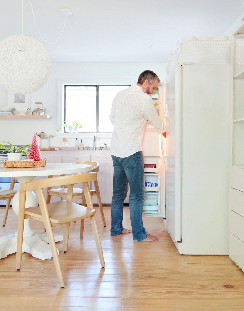 kitchen-split-shelves-john-at-fridge-804x1024-1 John standing with freezer door open next to round table in kitchen