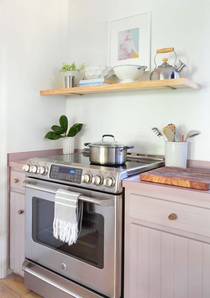 kitchen-split-shelves-stove-detail-723x1024-2 Stainless steel electric stove with mauve cabinets and floating wood shelf