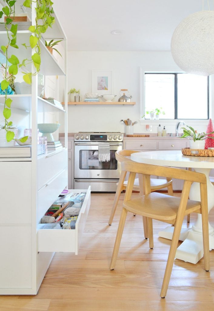 kitchen-split-shelves-tool-drawer-walkway-706x1024-2 Drawer open on metal shelf behind round table