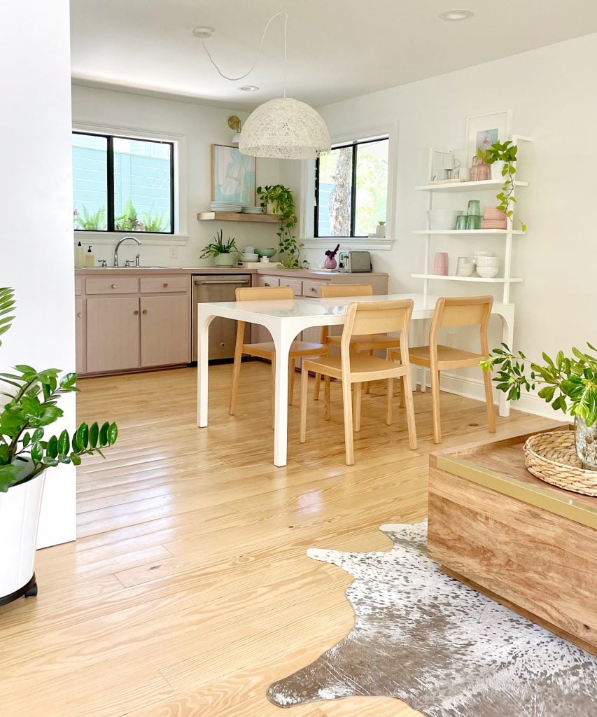 kitchen-update-vertical-shot-of-table-and-corner-window-853x1024-1 Vertical View Of Walking Space To Beachy Kitchen With Wood Furniture And Mauve Cabinets