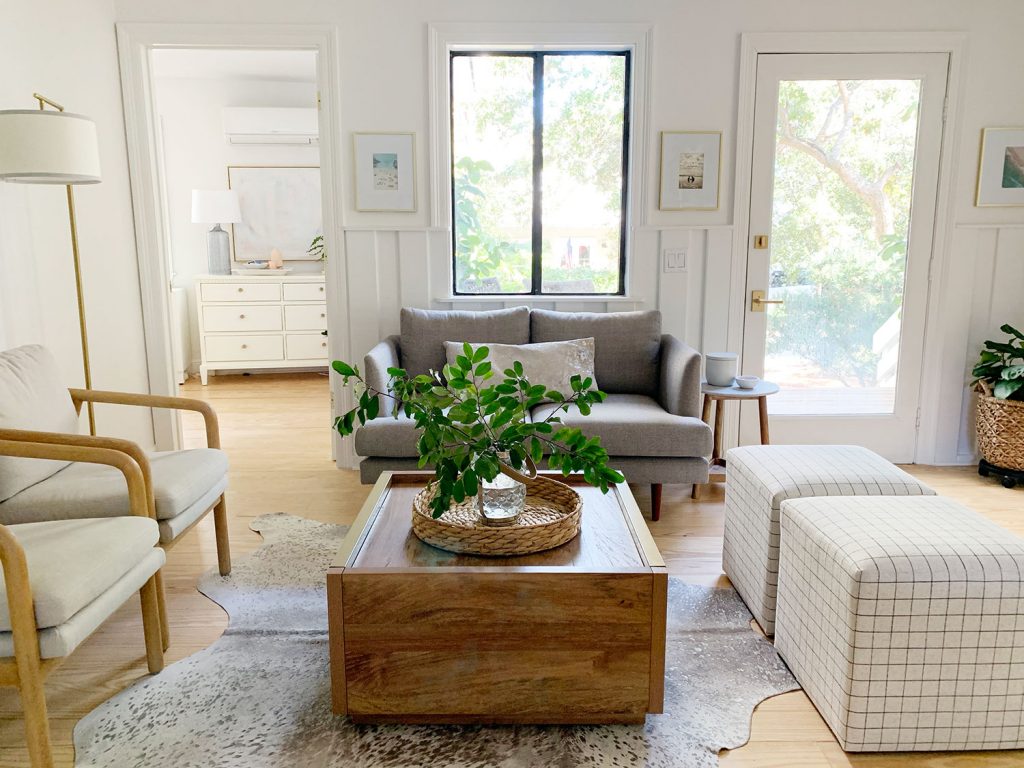 loveseat-living-room-sitting-area-wide-shot-at-window-1024x768-1 Sitting area including wood coffee table two plaid ottomans two arm chairs and gray loveseat