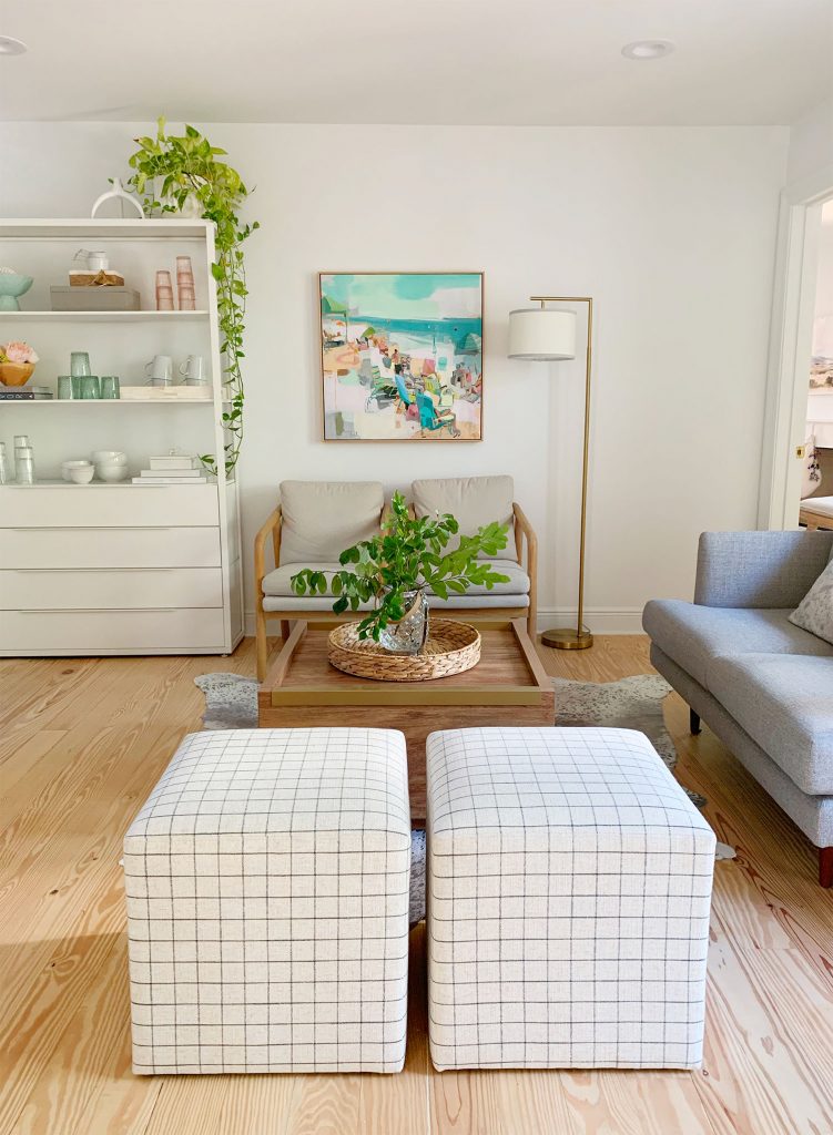 loveseat-side-wall-vertical-shot-751x1024-1 Straight view of sitting area with two plaid ottomans in foreground