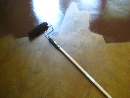 oilfloorpaintoverstain painting over a stained concrete floor with a roller