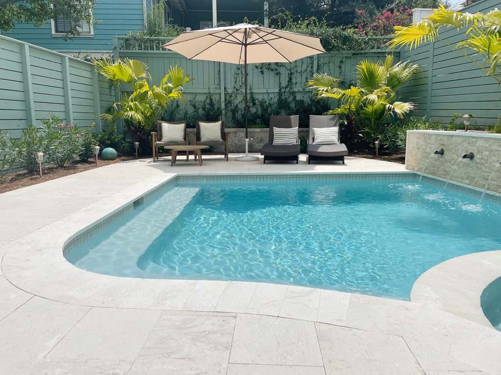 pool-post-after-shot-horizontal-towards-sitting-area-1024x768-1 Curved edge pool with seating area in the background with green fences