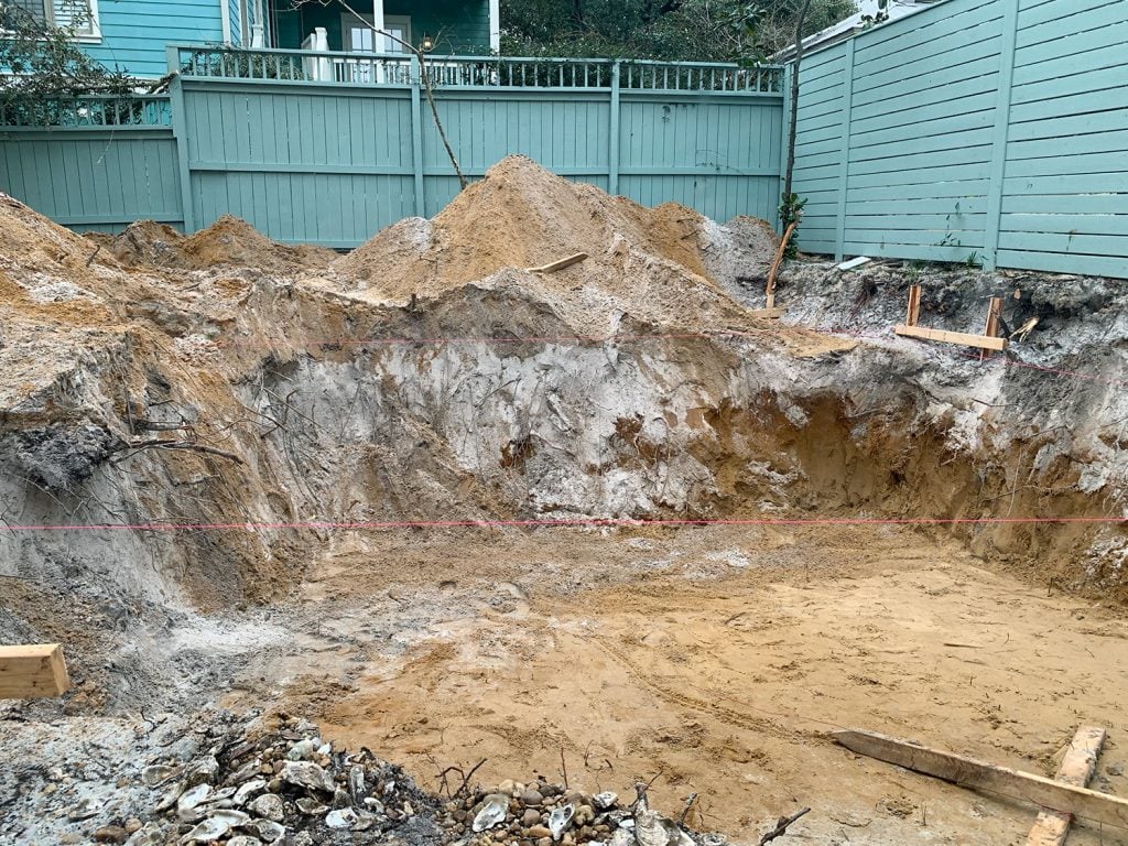 pool-post-dug-hole-sand-soil-1024x768-1 Large dirt hole dug in backyard where pool will be constructed