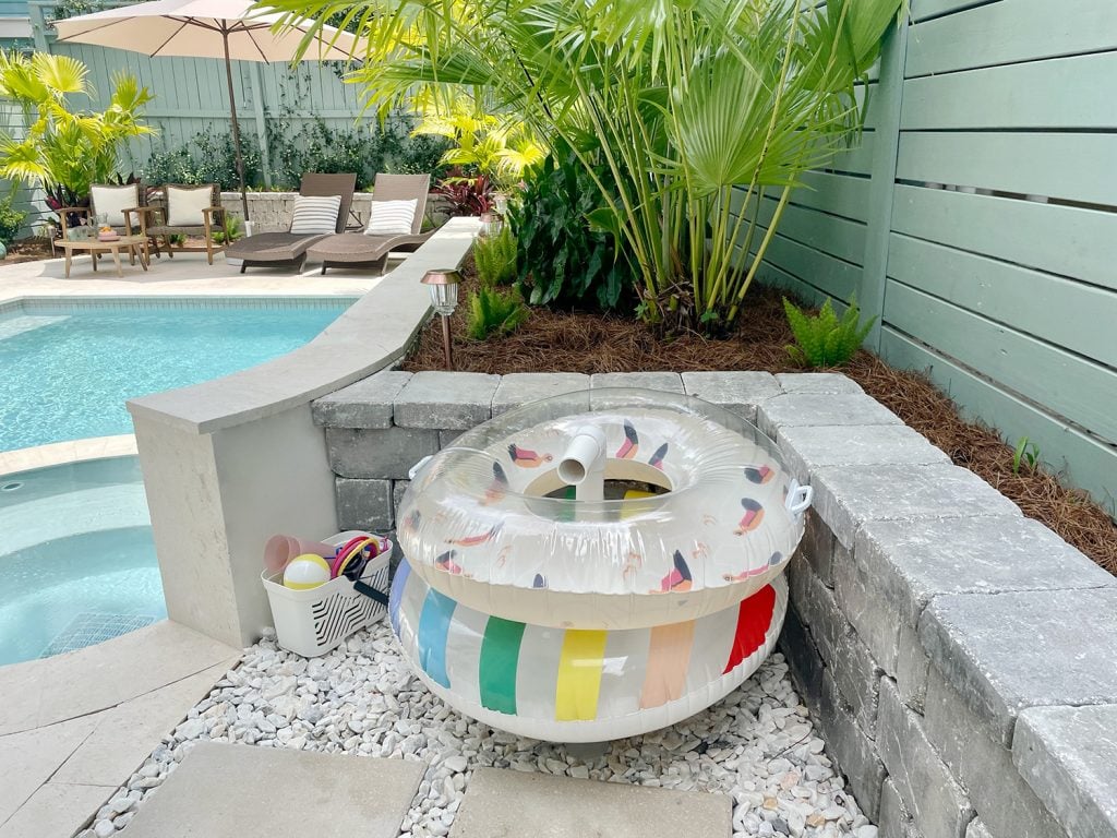 pool-post-float-storage-in-corner-pvc-pipe-1024x768-1 Pool floats organized on PVC pipe stand behind retaining wall