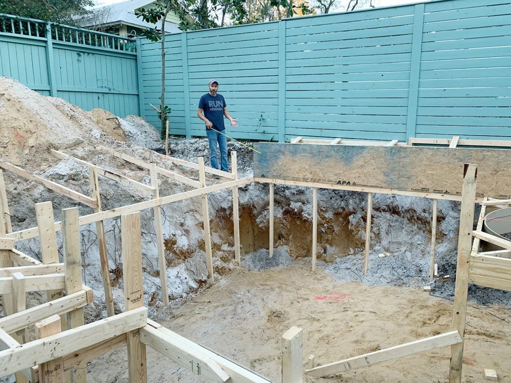 pool-post-framed-wood-pool-framing-process-photo-john-for-scale-1024x768-1 Pool hole framed out with wood and John in background with measuring tape