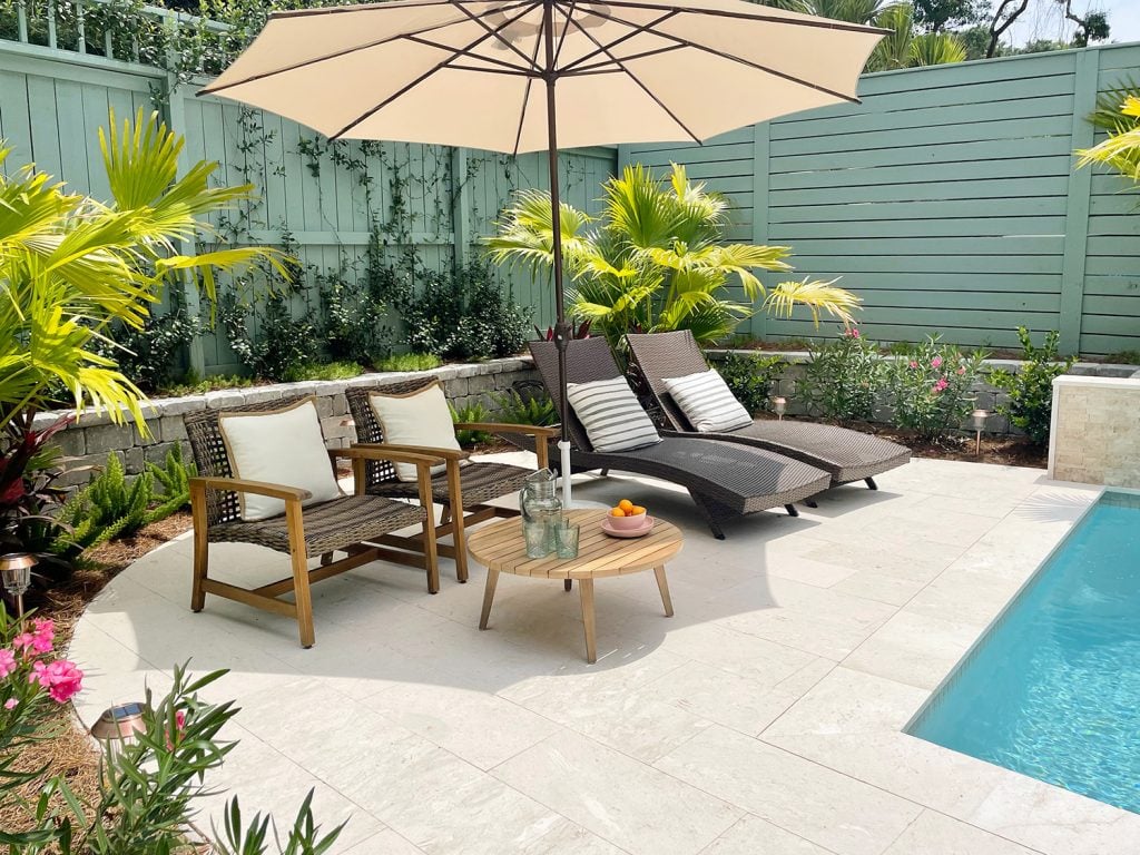 pool-post-horitzonal-sitting-area-pool-looks-neon-1024x768-1 Round pool patio area surrounded by tropical plantings Chinese palms oleander jasmine stonecrop foxtail ferns