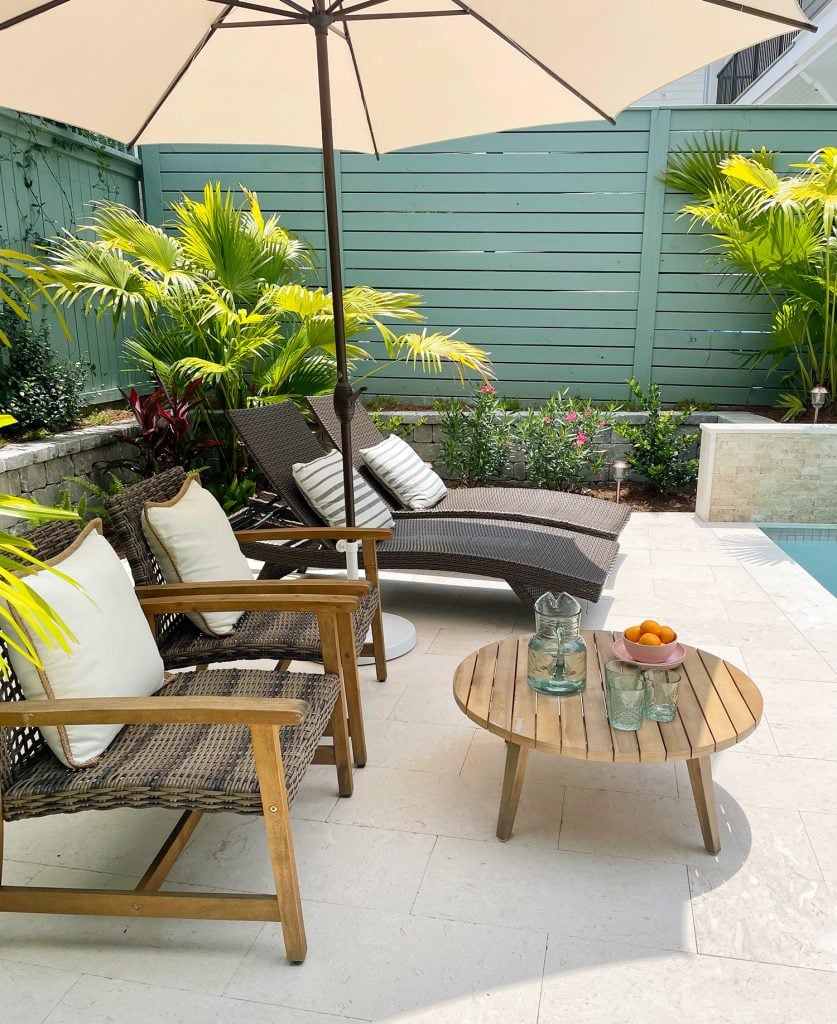 pool-post-vertical-photo-of-sitting-area-837x1024-1 Sideview of seating area with umbrella lounge chairs and small coffee table