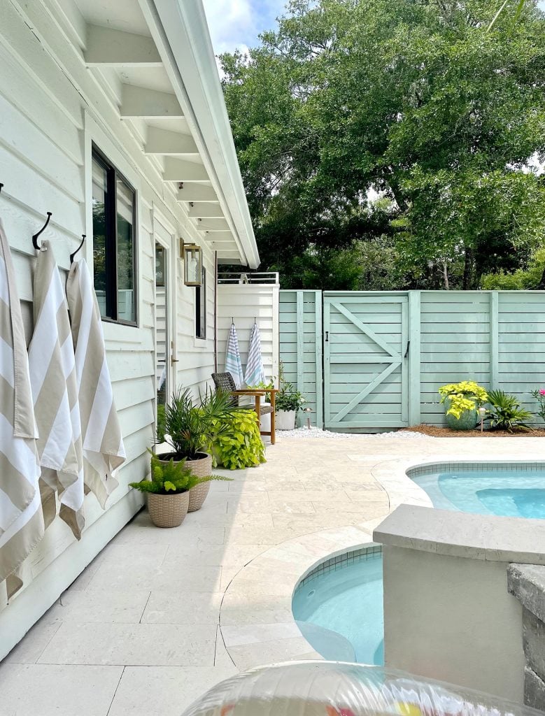 pool-post-vertical-side-of-house-towards-gate-big-tree-779x1024-1 Pool patio area with cream colored shellstone 12x24 travertine tiles