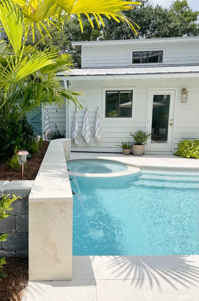 pool-post-vetical-side-of-wall-at-house-679x1024-1 Side view of pool accent wall with fountain sprayers and round spa in background