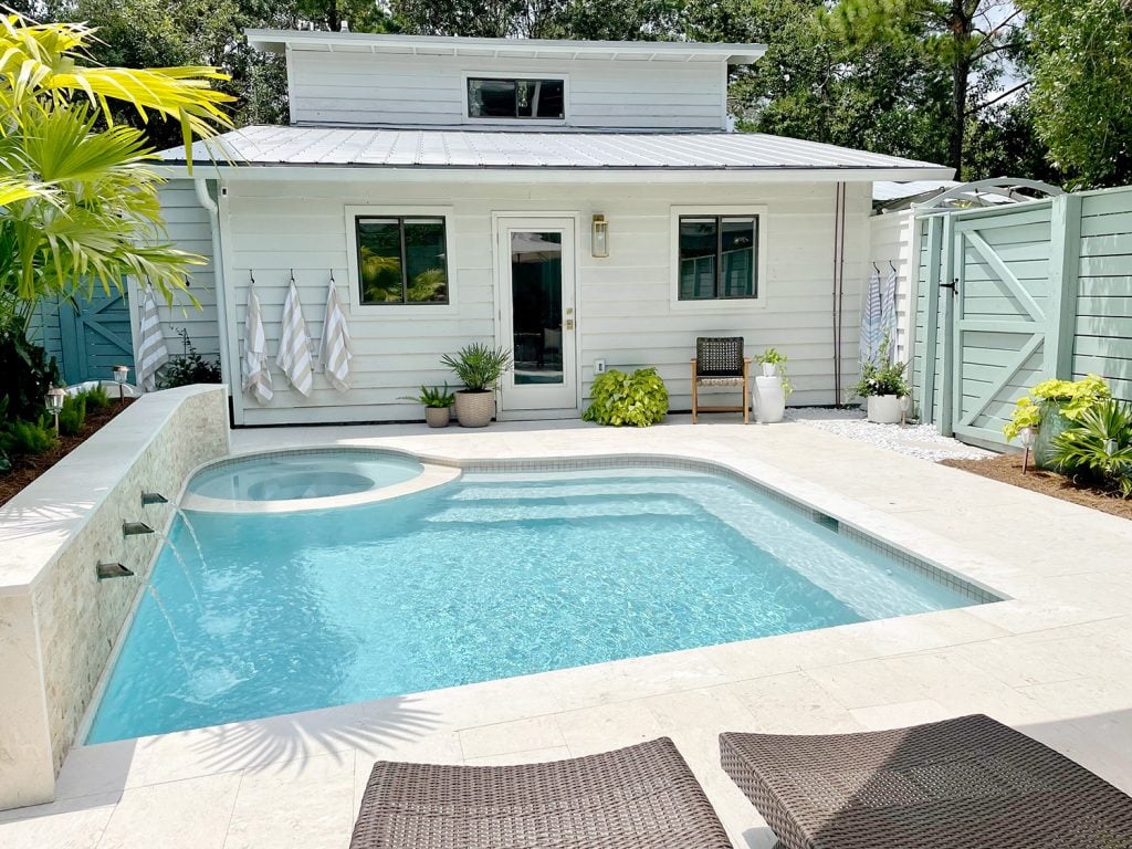 pool-post-wide-shot-towards-house-no-people-swimming-1024x768-1 Small freeform pool with white house metal roof in background