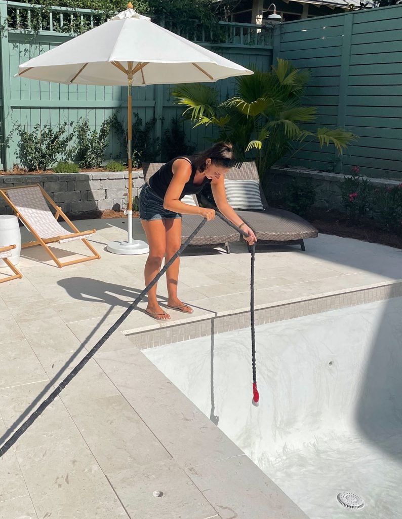 pool-process-sherry-filling-794x1024-1 Sherry dangling hose into plastered pool form to begin filling with water