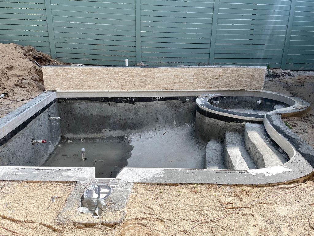 pool-process-tile-done-1024x768-1 Concrete pool with tile applied around waterline and across accent retaining wall