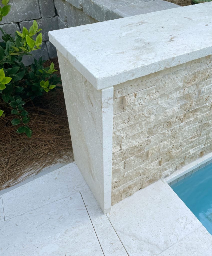 pool-wall-coping-detail-848x1024-1 Detail photo of shellstone travertine patio tile used along the side and top of tile accent wall