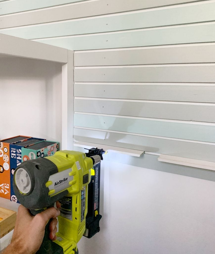 rainbow-stripe-wall-nailing-lower-part-869x1024-1 Nail Gun Attaching Smaller Lattice Pieces Onto Wall Next To Bookshelf