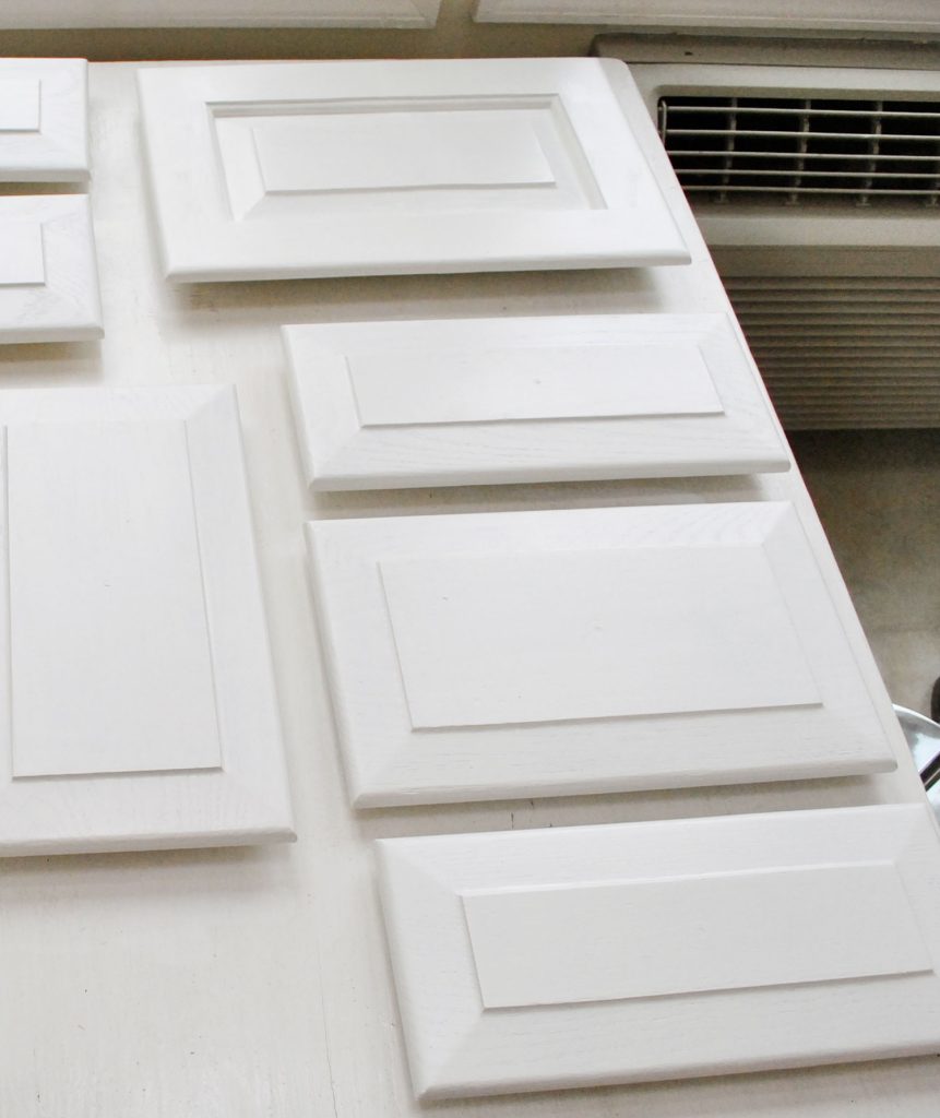 step-6-painted-cabinet-doors-white-861x1024-1 White Painted Kitchen Cabinet Doors Laid Out
